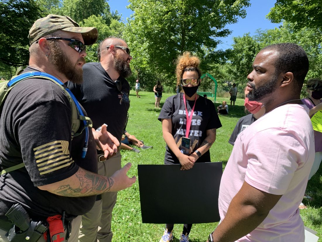 Skylar Steward, of Marietta, and Robert Hal, of Athens, introduce themselves to Dante and Haylee Sherman, of Cleveland, before the opening of the peaceful demonstration against racism in East Muskingum Park Sunday.